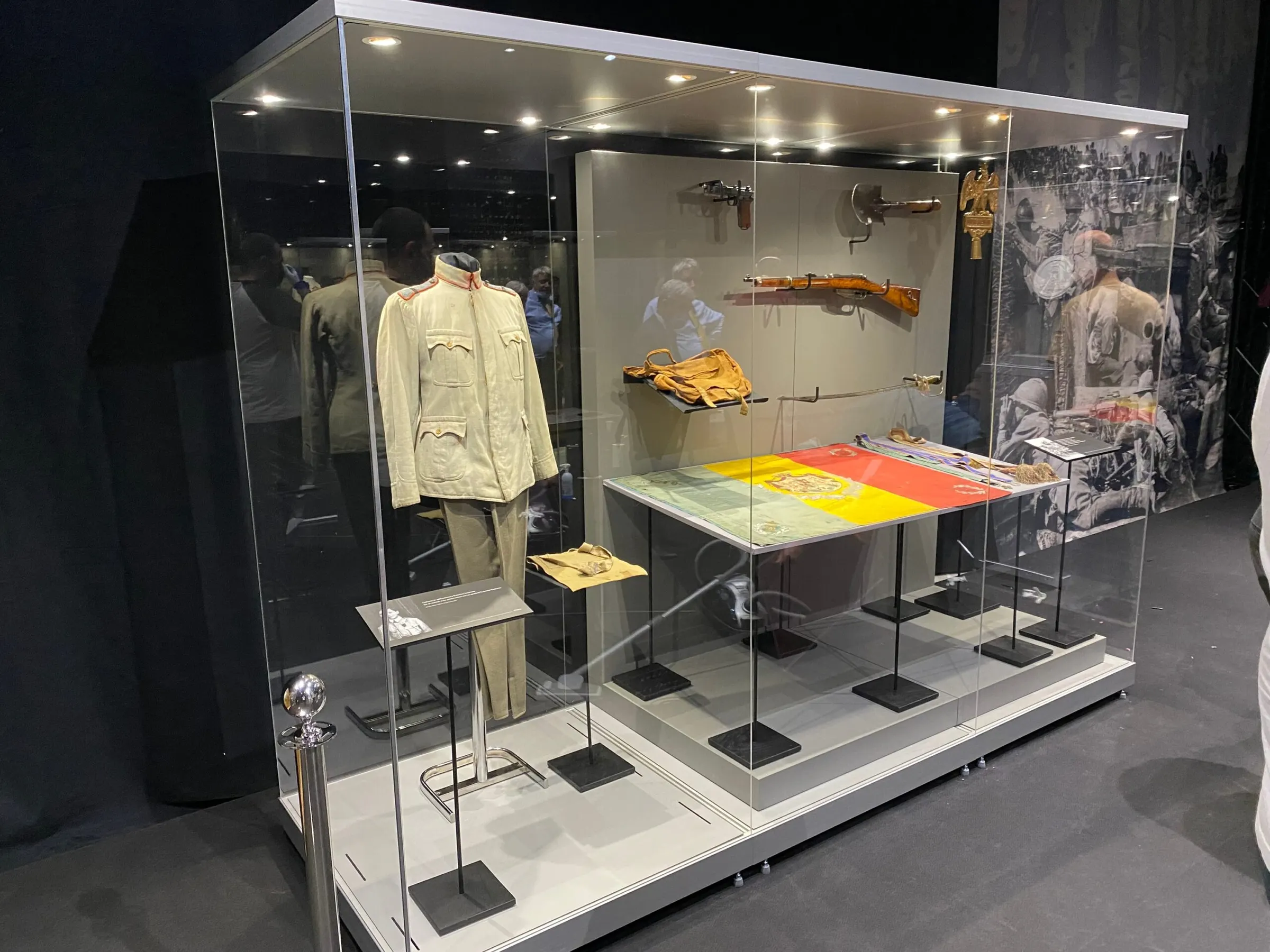 Lit display case with a uniform and period objects in a temporary exhibition at the National Bank of Romania Museum