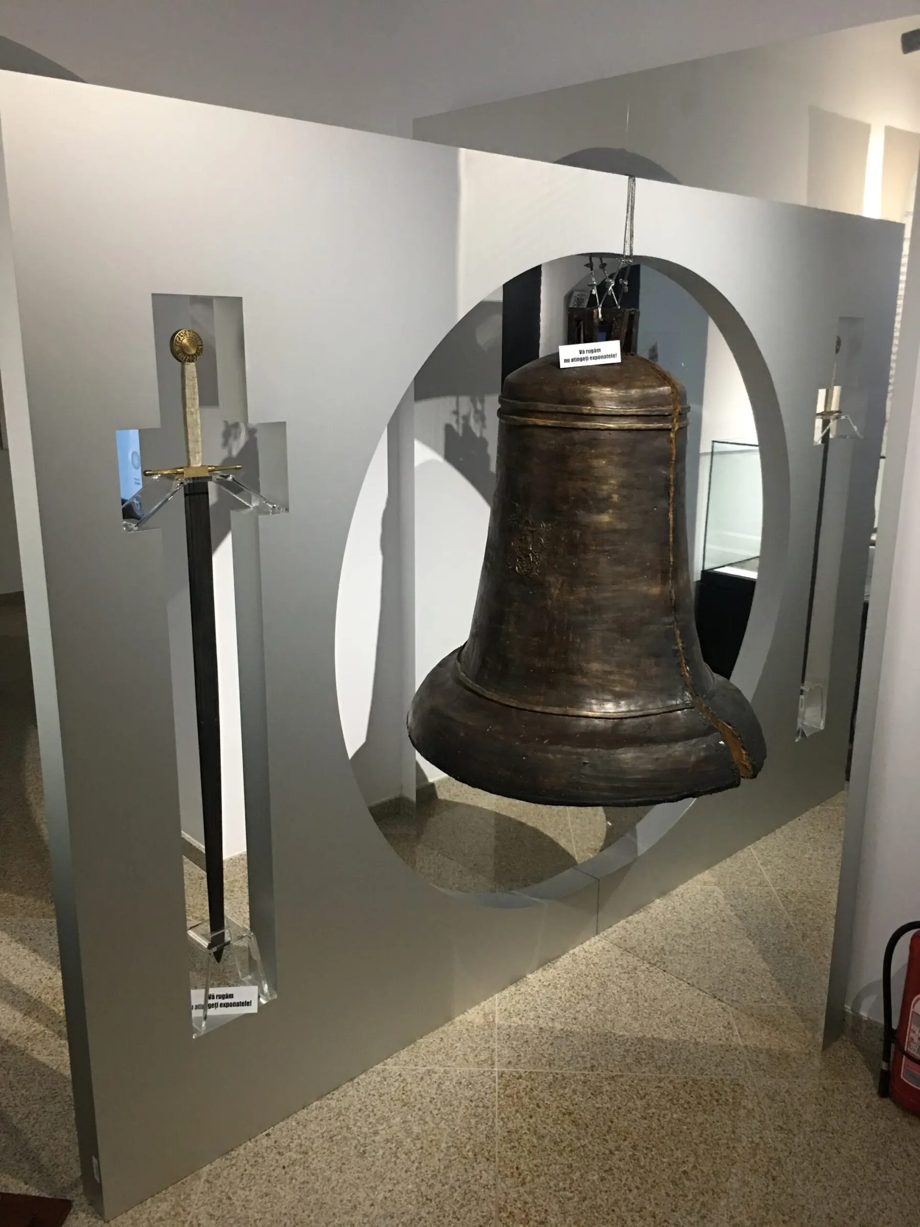 Exhibition panel with a bell and a sword at the National Museum of Bukovina